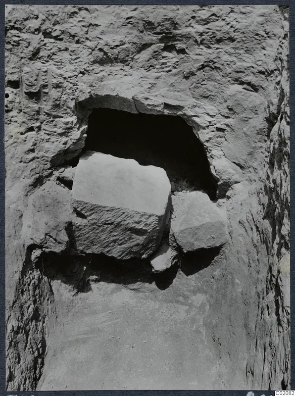Large cut stones lying in front of the opening of Tomb 78 at Marion during excavation