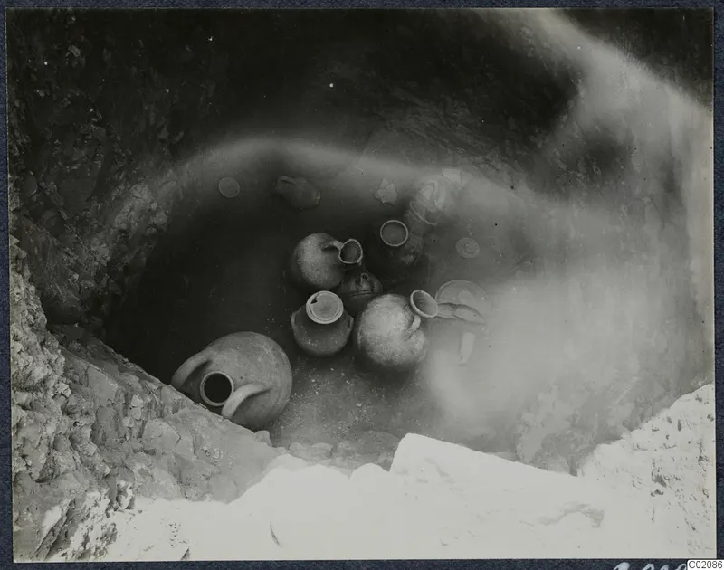 Pottery vessels in situ at the bottom of Tomb 80 at Marion during excavation