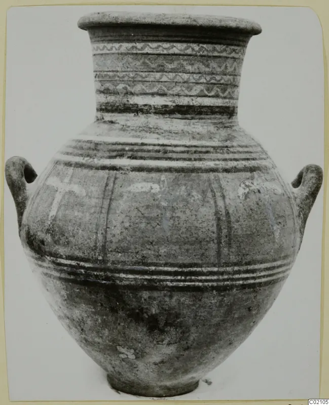 Two-handled pottery jar with banded and wavy painted decoration on its neck and body