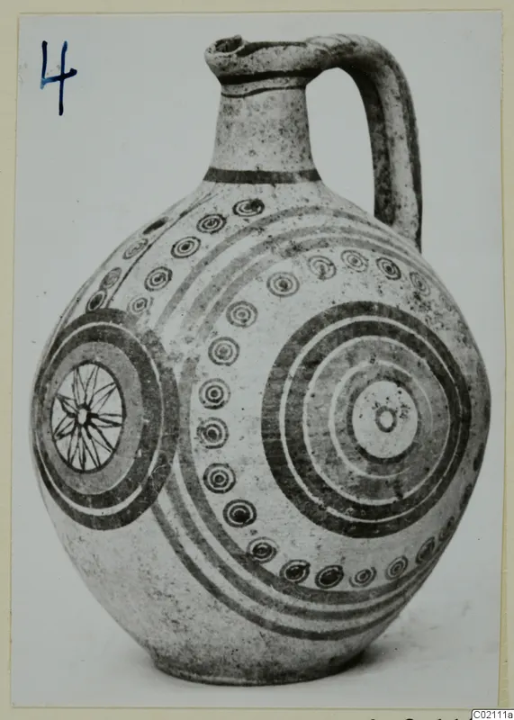 Pottery Bichrome IV jug with concentric circles, dotted rings and a star motif, photographed on a card mount