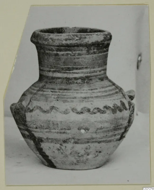 Small pottery amphoriskos with two handles and painted bands, with a wavy dark motif on the shoulder