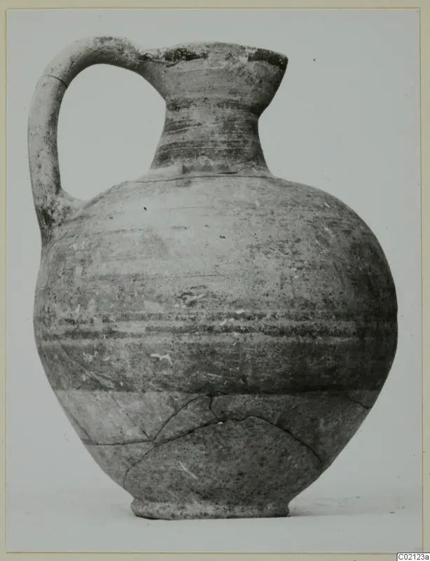 Pottery Bichrome V jug with a strap handle and horizontal painted bands, shown against a plain background