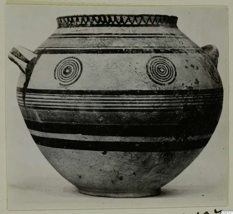 Globular pottery vessel with two handles, dark painted bands and concentric circles on the body