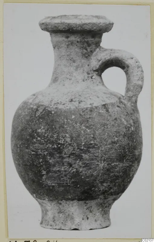 Pottery White Painted VII vessel with a single loop handle