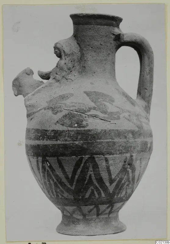 White Painted VII jug with a single handle, dark painted bands and a zigzag pattern on the body, shown on a card mount.