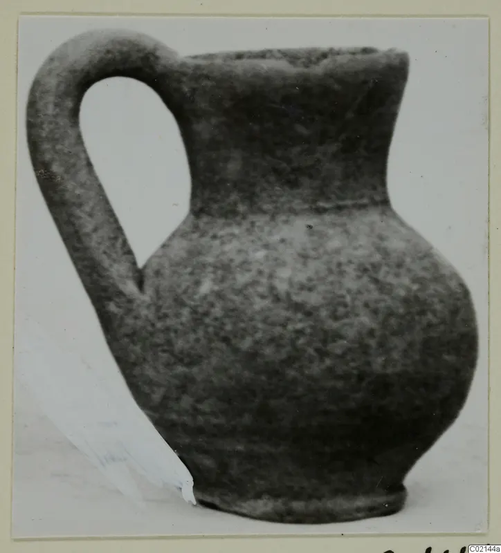 Pottery Plain White IV-V juglet with a tall loop handle, from the Marion tomb finds