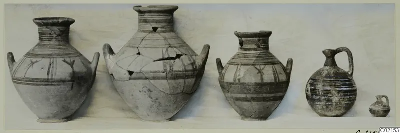 Five painted pottery vessels from Marion, Tomb 93, set in a row against a pale background