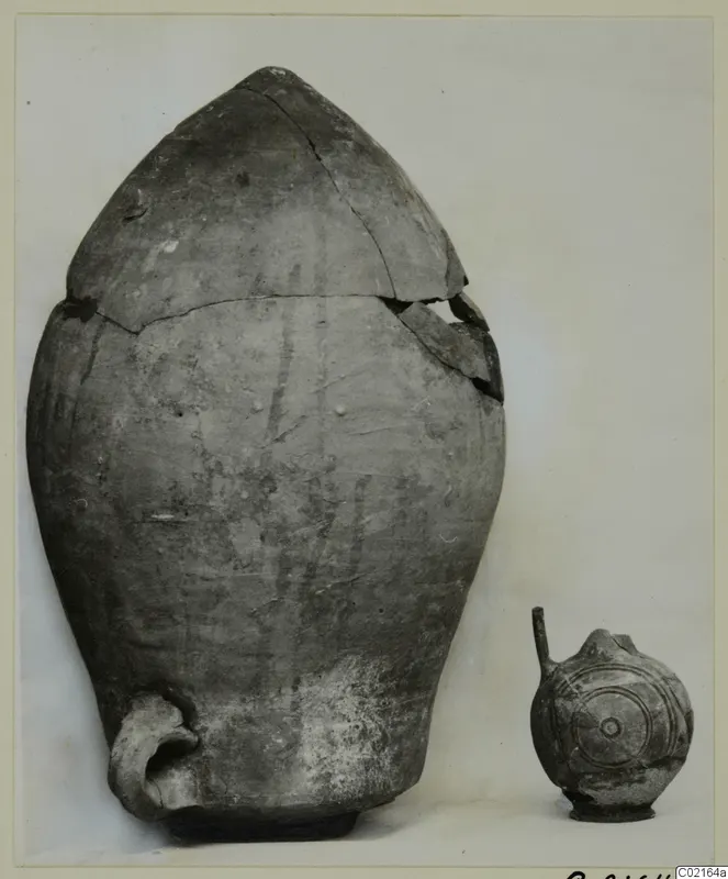 Large storage jar with a broken, pointed lid and a small juglet with concentric circles, from Marion Tomb 81 B.