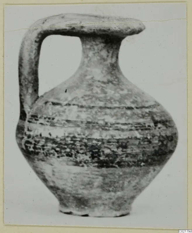 Pottery jug with a strap handle and dark painted bands, from tombs 61–98 at Marion