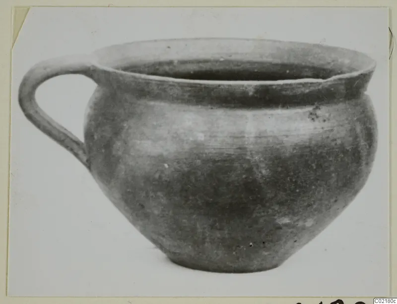 Handled pottery vessel with a wide mouth and rounded body, shown against a plain white background.