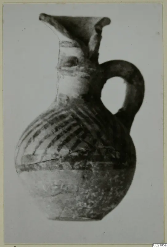Pottery jug with a single loop handle and dark painted bands on its body, from Idalion