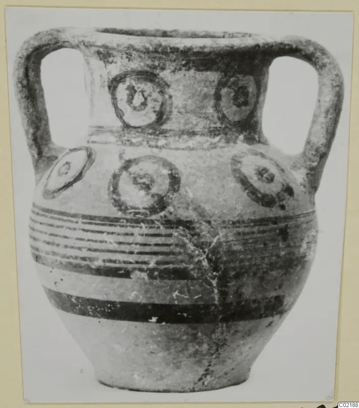Two-handled pottery vessel from Marion with circular motifs and horizontal dark bands