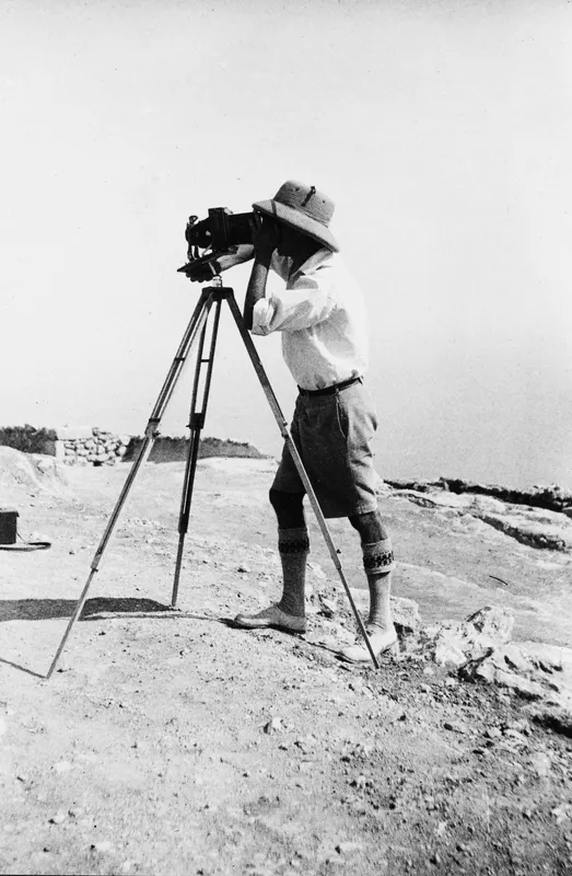 John Lindros photographing at Vouni, with a large camera on a tripod on a stony hilltop