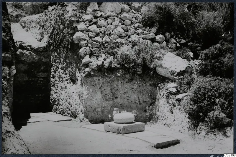 Trench 1 at Loures with a cement floor and a column base in situ against a stone wall