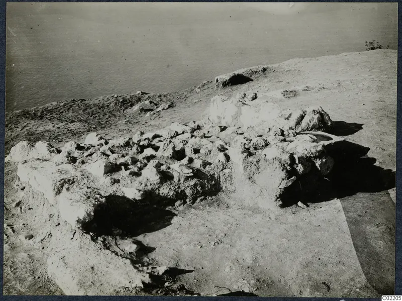 Collapsed stone walls of the palace at Vouni on a bare headland above the sea