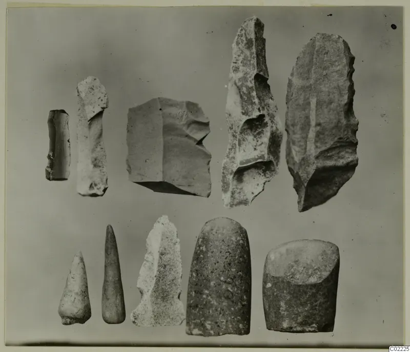 Ten worked stone objects in two rows, including blades, flakes and rounded tools, from Petra tou Limniti
