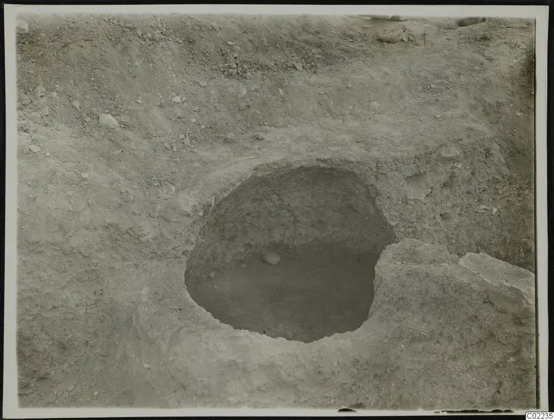 Excavated pit at Ayios Iakovos with a single stone lying on its floor