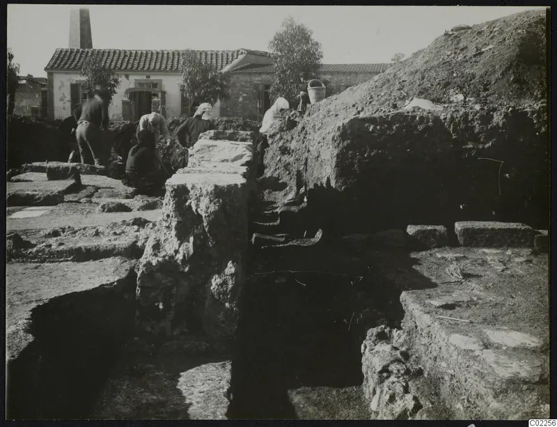 Excavation at Kition showing rooms 10 to 4 and working people among exposed stone walls