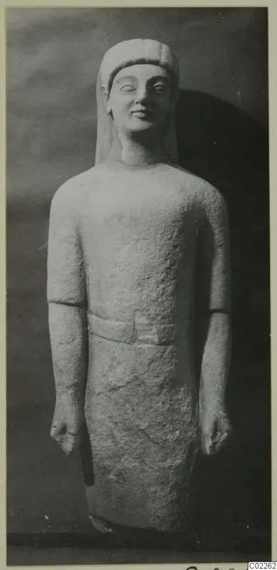 Limestone statue of a standing male figure, from Kition, photographed against a dark backdrop.