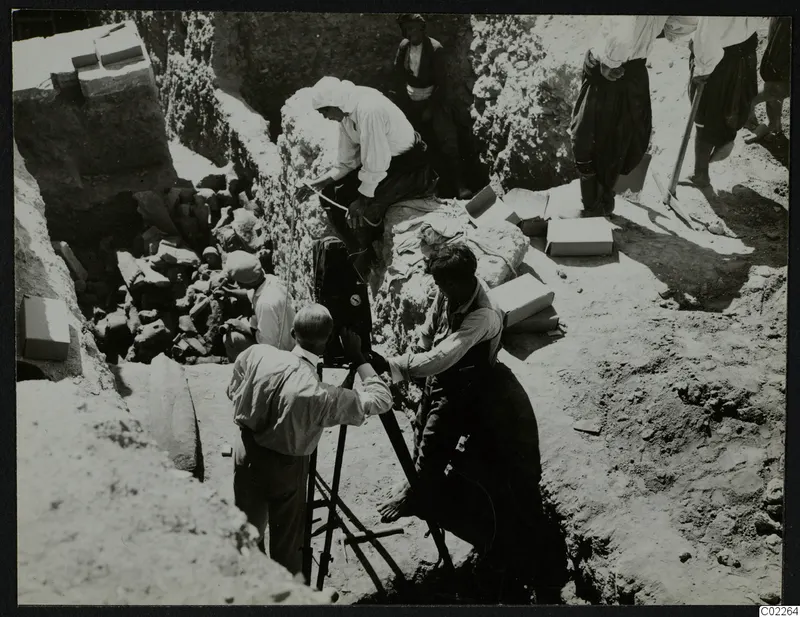 John Lindros filming at the excavation in Kition, with workers and boxes of finds around the trench