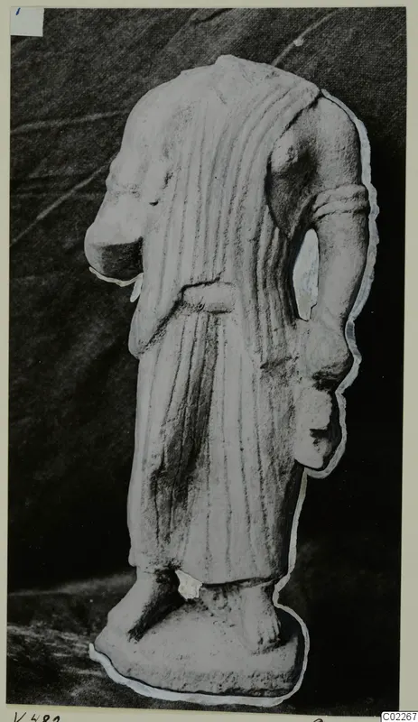 Headless limestone statue from Vouni in a long pleated garment with a belt