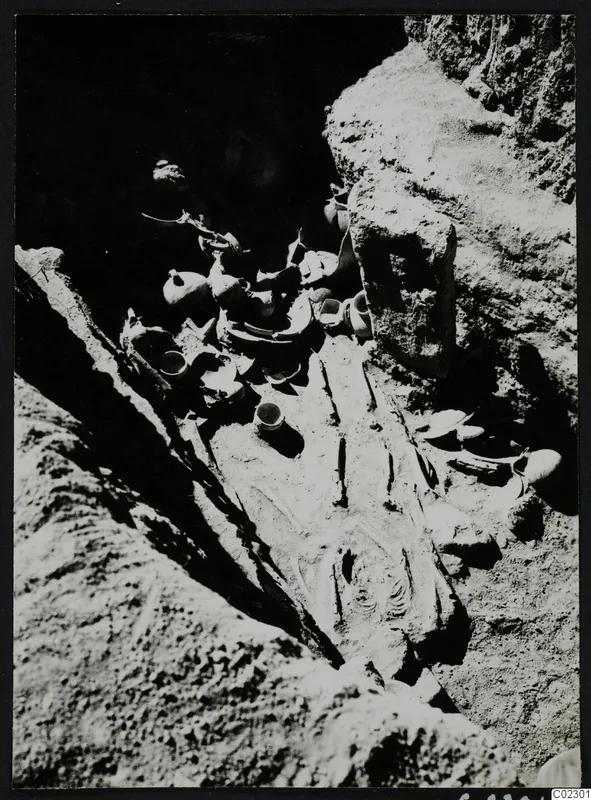 Skeleton with pottery vessels in a rock-cut tomb at Amathus during excavation