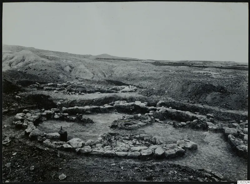 Excavated stone foundations of a building at Kythrea, with hills in the background