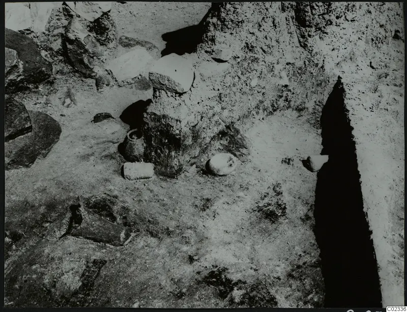 Excavation at Kythrea with small vessels and stones lying on the excavated ground