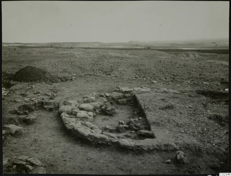Excavation at Kythrea showing a stone construction of low walls in open, stony ground