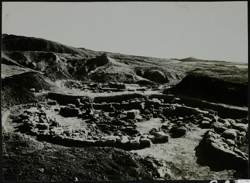 Excavation at Kythrea showing low stone walls and foundations in a trench on a hillside