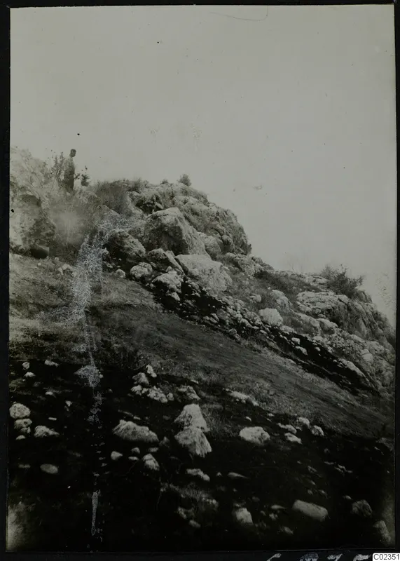 Rocky hillside at Petra tou Limniti with one person standing among the stones near the top