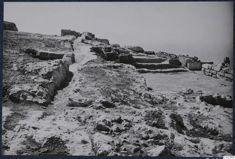 Excavated ground at Vouni palace with cut stone blocks, a low wall and a stone staircase