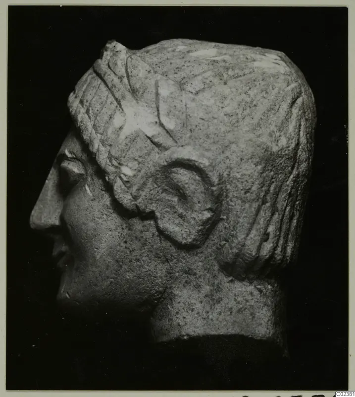 Limestone head in profile facing left, from Kition, with ridged hair bands and a carved ear