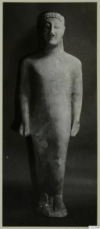Limestone statue of a standing figure from Kition, shown full length against a dark background.