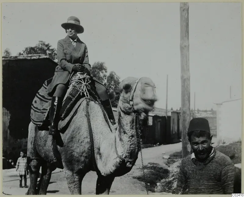 Vivi Gjerstad riding a camel along a street in Nicosia