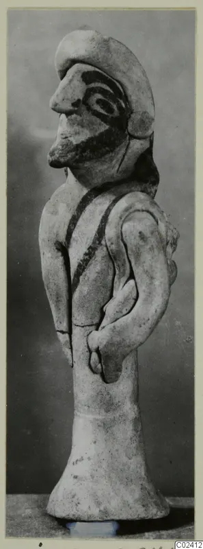 Terracotta figurine from Ayia Irini of a standing figure in profile, with painted face and dark chest bands