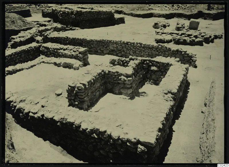 Excavated rubble stone walls at Ayia Irini, with a spoil heap at the upper left