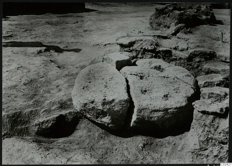 Excavation at Ayia Irini with two large rounded stone blocks in situ and rubble stones around them