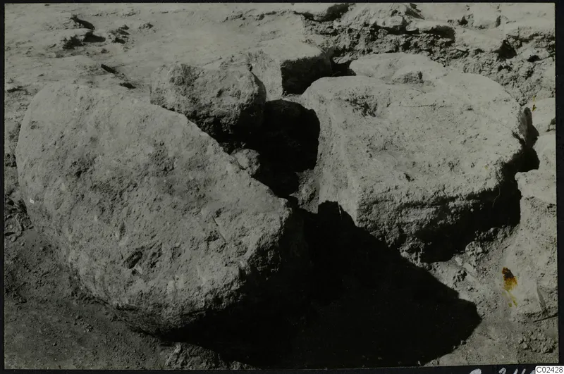 Large worked stone blocks lying in excavated ground at Ayia Irini