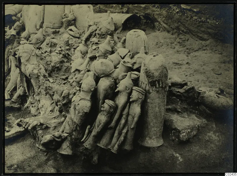 Excavation of Ayia Irini, square K 10,11, with a crowded cluster of clay figures lying in situ in the soil.