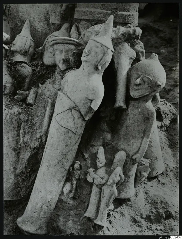 Several figurines in situ in excavation soil at Ayia Irini