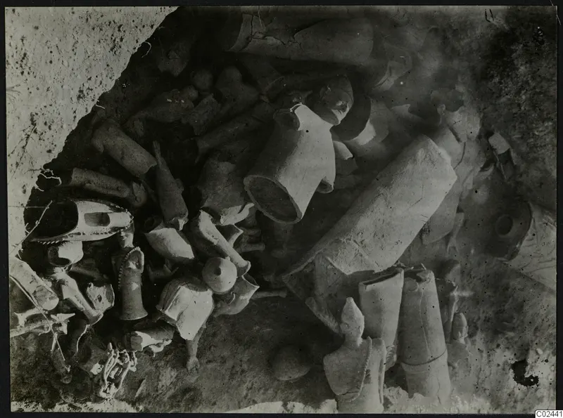 Clay figurines and fragments lying in situ in excavated soil at Ayia Irini