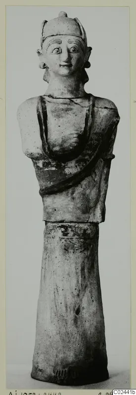 Terracotta Neo-Cypriote statue of a figure with a cap-like headdress and a bust on a tall flaring base, from Ayia Irini