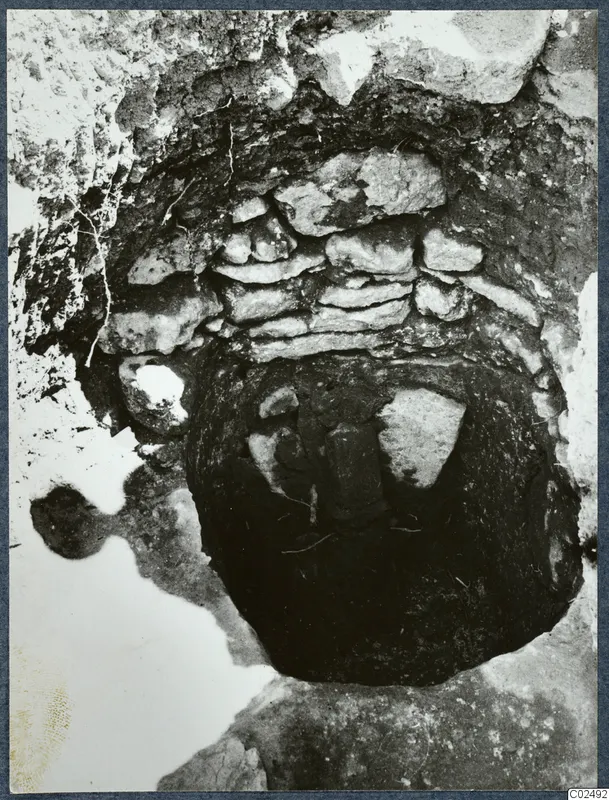 Tomb chamber at Enkomi seen from above, with a stone-built wall and dark opening