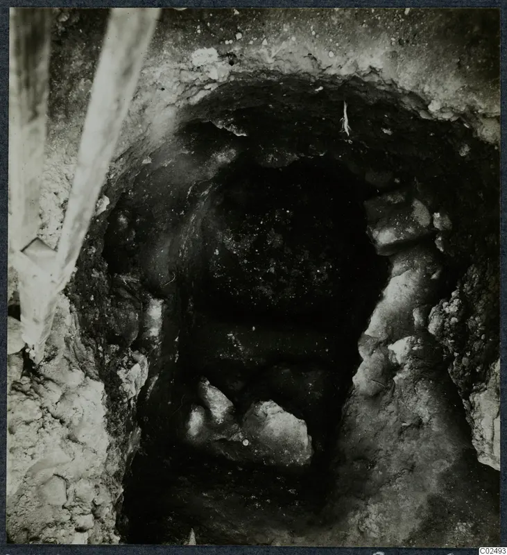 Tomb 9 at Enkomi: dark tomb chamber opening with stones, seen during excavation