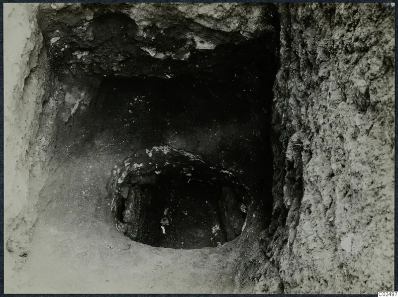 Tomb 13 at Enkomi during excavation, with a tomb chamber opening and stones at its entrance