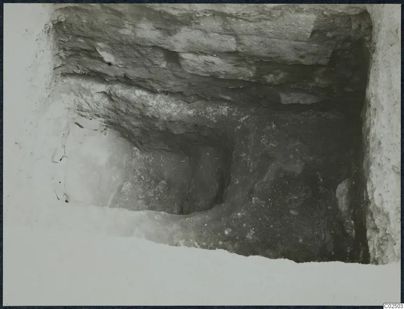 Tomb 3 at Enkomi during excavation: looking into a tomb chamber cut through layered soil