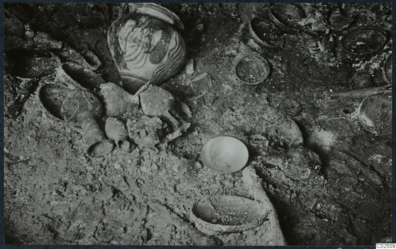 Tomb 17 at Enkomi: tomb chamber floor during excavation, with a painted jar and bone fragments among finds in situ