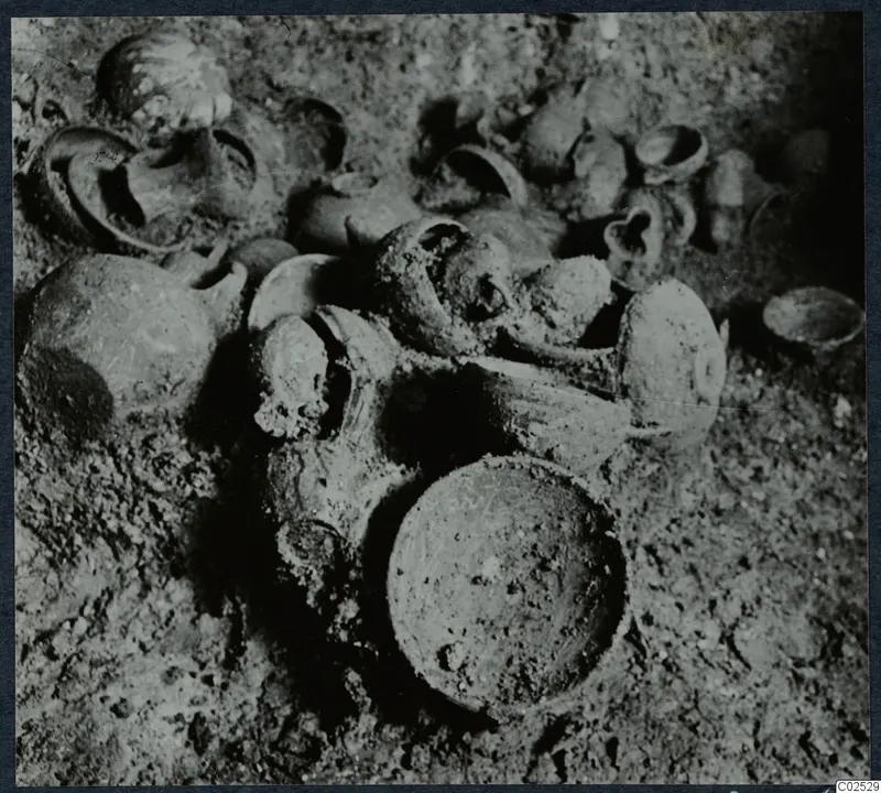 Pottery vessels lying in soil inside Tomb 13 at Enkomi during excavation