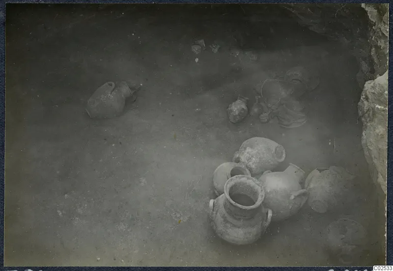 Pottery vessels and sherds lying on the floor of Tomb 98 at Marion, seen from above